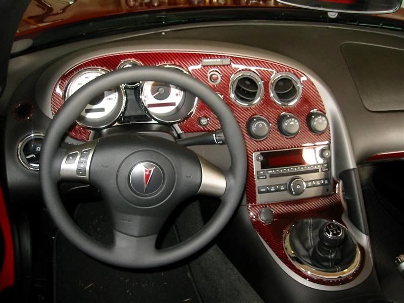 Red and black Carbon Fiber dash kit installed on aggressive sol